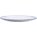 A white oval melamine dinner plate with a blue rim.