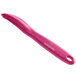 A pink Victorinox vegetable peeler with a white background.