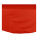 A red round table cloth with hemmed edges.