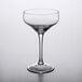 An Arcoroc Mix Collection tall coupe wine glass on a white surface.