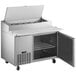 An Avantco stainless steel refrigerated pizza prep table with a door open.