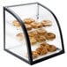 A Cal-Mil black iron bakery display case with bagels on it.