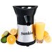 A Sunkist Pro Series citrus juicer with a glass of orange juice and limes, lemons, and an orange.