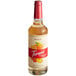 A Torani Puremade Peach Flavoring Syrup 750 mL glass bottle of peach syrup.