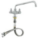 A chrome Equip by T&S deck-mounted faucet with a swing spout and lever handles.
