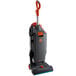 A grey Hoover HushTone bagged upright vacuum cleaner with an orange handle and cables.