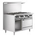 A large stainless steel U.S. Range commercial gas range with 4 burners, a griddle, and a cabinet base.