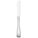 A stainless steel Libbey dinner knife with a white handle.
