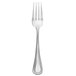 A Libbey stainless steel dinner fork with a silver handle and prongs.