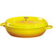 A round yellow enamel coated cast aluminum pot with a lid.