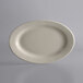 A white oval stoneware platter with a rolled edge on a white background.