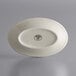 A white oval stoneware platter with a rolled edge.