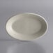 A Libbey Princess White oval stoneware platter on a gray surface.