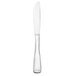 A Libbey stainless steel dinner knife with a white handle and long blade.