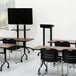 A black Safco mobile steel lectern in a classroom.