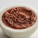 A bowl of Ghirardelli Sweet Ground Dark Chocolate & Cocoa Powder.