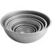 A stack of five Vollrath heavy-duty stainless steel mixing bowls.