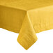 A folded edge yellow Hoffmaster table cover on a table.