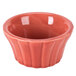 A white china ramekin with a red floral rim.