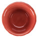 A close-up of a red bowl with a white background.
