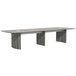 A Safco Medina rectangular conference table with steel gray top and two legs.