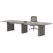 A Safco Medina steel gray rectangular conference table with chairs and a pad on it.