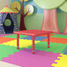 A red Flash Furniture square adjustable height activity table in a colorful playroom.