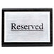 An American Metalcraft black wood "Reserved" sign on a table.