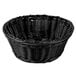 A black round rattan basket with a handle.