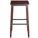 A Lancaster Table & Seating backless bar stool with mahogany finish and metal legs.