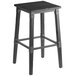 A Lancaster Table & Seating black backless bar stool with a wooden seat.
