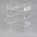 A clear acrylic Cal-Mil cake and pie display case with four compartments and white handles.