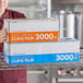 A woman holding a box of Choice 18" x 3000' foodservice film.