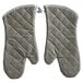 A pair of grey quilted oven mitts.