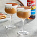 Two glasses of coffee with brown liquid and white and brown toppings using Torani Tiramisu Flavoring Syrup.