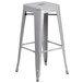 A Flash Furniture silver metal bar height table with 2 square seat backless stools.