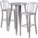 A Flash Furniture metal bar table with silver stools.