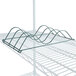 A green wire rack with spiral design on a metal shelf.