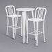 A Flash Furniture white metal bar height table with two white vertical slat back stools.