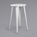A white metal Flash Furniture cafe stool with legs.