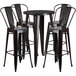 A Flash Furniture black metal bar height table with four black metal chairs.