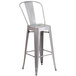 A Flash Furniture silver metal bar stool with a backrest.