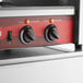 An Avantco hot dog roller grill control panel with two knobs.