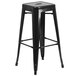 A black metal square seat backless stool.
