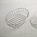 Two American Metalcraft stainless steel wire baskets on a white surface.