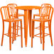 An orange metal round bar table with 4 orange stools.