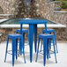 A Flash Furniture blue metal bar height table with blue square stools.