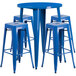 A blue metal round table with four square stools.