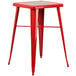 A Flash Furniture red metal square bar height table with red metal square legs and 2 red metal square backless stools.