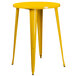 A yellow metal round bar height table with legs.
